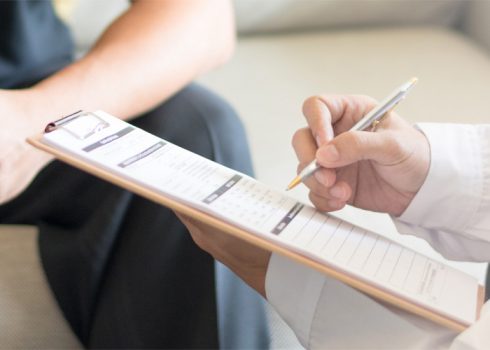 practitioner filling out a screening form