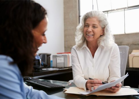 older practitioner talking to a client