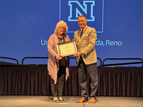 nancy and president sandavol giving awards